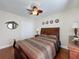 Bedroom showcasing a wood bed frame, wood floors, a ceiling fan, and decorative wall art at 2316 Paulette Dr, Haines City, FL 33844