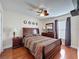 Bedroom featuring a wood-framed bed, wood floors, a ceiling fan, and a window with natural light at 2316 Paulette Dr, Haines City, FL 33844