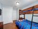 Bedroom featuring bunk beds, hardwood floors, and a closet, offering ample space and storage at 2316 Paulette Dr, Haines City, FL 33844