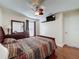 Bedroom with wood floors, a ceiling fan, a wall-mounted TV, and a window with curtains at 2316 Paulette Dr, Haines City, FL 33844