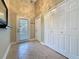 Inviting foyer featuring tiled floors, closet, and exterior door that brightens the entrance at 2316 Paulette Dr, Haines City, FL 33844