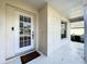 Close-up of the front door featuring a glass window, decorative trim, and a welcoming entrance at 2316 Paulette Dr, Haines City, FL 33844