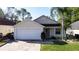 Charming single-story home featuring a two-car garage and inviting curb appeal with mature landscaping at 2316 Paulette Dr, Haines City, FL 33844