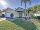 Inviting single-story home with a two-car garage, well-kept lawn, and attractive landscaping elements at 2316 Paulette Dr, Haines City, FL 33844