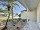 View of the front yard showcasing rock landscaping, mature landscaping, and curb appeal at 2316 Paulette Dr, Haines City, FL 33844