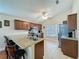 Well-lit kitchen featuring granite countertops, stainless steel appliances, and a breakfast bar at 2316 Paulette Dr, Haines City, FL 33844