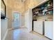 Laundry room offers tile floors, modern appliances, convenient storage shelving, and natural lighting at 2316 Paulette Dr, Haines City, FL 33844