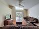 Comfortable living space with hardwood floors, ample light from slider, and a ceiling fan for added air flow at 2316 Paulette Dr, Haines City, FL 33844