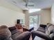 Warm and inviting living room featuring hardwood floors, ceiling fan, and sliding glass doors to the outdoor area at 2316 Paulette Dr, Haines City, FL 33844