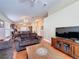 Open-concept living room featuring wood floors, a ceiling fan, and a view into the kitchen and dining area at 2316 Paulette Dr, Haines City, FL 33844