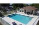 The community pool area is fenced and features lounge chairs, tables, and a covered area at 2316 Paulette Dr, Haines City, FL 33844