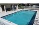 The community pool area features a clear, blue swimming pool, and a pool house with comfortable lounge chairs at 2316 Paulette Dr, Haines City, FL 33844