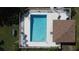 Top-down aerial photograph displays a rectangular community pool with surrounding patio furniture and a covered area at 2316 Paulette Dr, Haines City, FL 33844