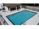 This community pool features a diving area, steps for easy entry, and a covered area with lounge chairs at 2316 Paulette Dr, Haines City, FL 33844