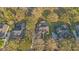 An aerial view shows the home's location among lush landscaping and its private backyard with large lawn at 2515 Ridgewind Way, Windermere, FL 34786