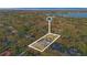 Aerial view showcasing a beautiful property with mature trees and a glimpse of the nearby lake and surrounding community at 2515 Ridgewind Way, Windermere, FL 34786