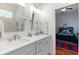 Bright bathroom featuring double sinks, white countertops, and a glimpse into a cozy bedroom at 2515 Ridgewind Way, Windermere, FL 34786