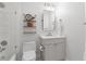 Well-lit bathroom with white tile, gray vanity, decorative shelf, and modern fixtures at 2515 Ridgewind Way, Windermere, FL 34786