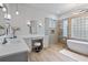 Bright bathroom featuring double vanity, modern fixtures, glass shower, and soaking tub at 2515 Ridgewind Way, Windermere, FL 34786
