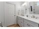 Bathroom with double vanity, white cabinets, and modern fixtures at 2515 Ridgewind Way, Windermere, FL 34786