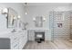 Bright bathroom featuring double vanity, modern fixtures, glass shower, and makeup vanity at 2515 Ridgewind Way, Windermere, FL 34786