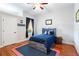 Bedroom with blue bed, wooden floors, and baseball-themed decor at 2515 Ridgewind Way, Windermere, FL 34786