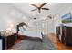 Large primary bedroom with wood floors, a ceiling fan, and closet space at 2515 Ridgewind Way, Windermere, FL 34786