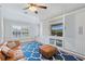 Bonus room featuring custom built-ins with a television, a leather sofa, and a striking blue rug at 2515 Ridgewind Way, Windermere, FL 34786