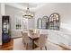 Bright dining room featuring wood floors, modern lighting, and decorative mirrors at 2515 Ridgewind Way, Windermere, FL 34786
