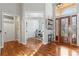 Bright foyer with an office view, rich wood floors, and transom windows at 2515 Ridgewind Way, Windermere, FL 34786