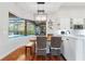 Bright eat-in kitchen with a pool view, wine rack and modern light fixture at 2515 Ridgewind Way, Windermere, FL 34786