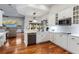 Modern white kitchen featuring stainless steel appliances, sleek countertops, and a herringbone backsplash at 2515 Ridgewind Way, Windermere, FL 34786