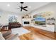 Inviting living room with a cozy fireplace, vaulted ceilings, and a large window for natural light at 2515 Ridgewind Way, Windermere, FL 34786