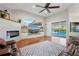 Open living room with fireplace, pool view, and vaulted ceilings at 2515 Ridgewind Way, Windermere, FL 34786