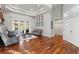 Comfortable living room with stylish decor, hardwood floors, and access to the pool area through French doors at 2515 Ridgewind Way, Windermere, FL 34786