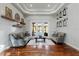 Bright living room featuring hardwood floors, tray ceilings, and French doors leading to a pool at 2515 Ridgewind Way, Windermere, FL 34786