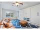 Bright living room with built-in cabinets, leather couch, and patterned rug at 2515 Ridgewind Way, Windermere, FL 34786