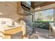 This outdoor kitchen features a stainless steel grill, sink, and a flat screen TV for outdoor entertainment at 2515 Ridgewind Way, Windermere, FL 34786