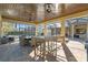A spacious outdoor living area with seating, tongue and groove ceiling and bar height table at 2515 Ridgewind Way, Windermere, FL 34786