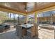 An open-air patio area features an outdoor seating set and dining table with a spa in the background at 2515 Ridgewind Way, Windermere, FL 34786