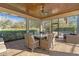 A screened-in patio with a beautiful tongue and groove ceiling and outdoor furniture with an expansive view at 2515 Ridgewind Way, Windermere, FL 34786