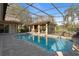 A private pool and hot tub area with brick pavers and a screened enclosure offers a relaxing outdoor retreat at 2515 Ridgewind Way, Windermere, FL 34786