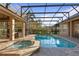 A well-maintained private pool and hot tub area with brick pavers surrounded by manicured landscaping at 2515 Ridgewind Way, Windermere, FL 34786