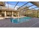 A stunning screened-in pool area with a covered lanai and spa offers a luxurious outdoor living space at 2515 Ridgewind Way, Windermere, FL 34786