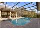 A stunning private pool with a spa and outdoor kitchen surrounded by a screened enclosure at 2515 Ridgewind Way, Windermere, FL 34786