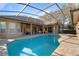 A spacious private pool area with spa features an oversized screened lanai and brick paver deck at 2515 Ridgewind Way, Windermere, FL 34786