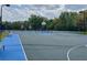 Well-maintained basketball court featuring blue and grey surface, lighting, and seating at 2604 Lodi Cir # 103, Kissimmee, FL 34746