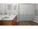 Bathroom features a sink with a large mirror, shower, tub and modern vanity at 2604 Lodi Cir # 103, Kissimmee, FL 34746