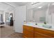 Bathroom showcases a sink with a large mirror and access to the Primary bedroom at 2604 Lodi Cir # 103, Kissimmee, FL 34746