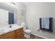 Bathroom features a single sink vanity, toilet, wood-look tile flooring, and neutral paint at 2604 Lodi Cir # 103, Kissimmee, FL 34746
